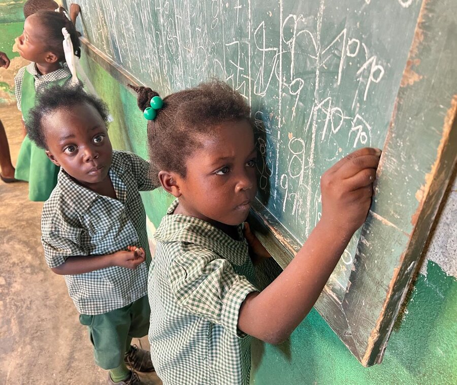 Children writing on a blackboard in Port-au-Prince, Haiti. Photo: WFP/Tanya Birkbeck