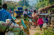 A sea of people walking down a dirt road, carrying their belongings. Photo: WFP/Biobei Malenga