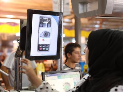 Photo: WFP/Mohammad Batah Syrian refugee pays for groceries using a scan of her iris. WFP introduces Iris Scan Technology to provide food assistance to Syrian refugees in Zaatari Refugee Camp.